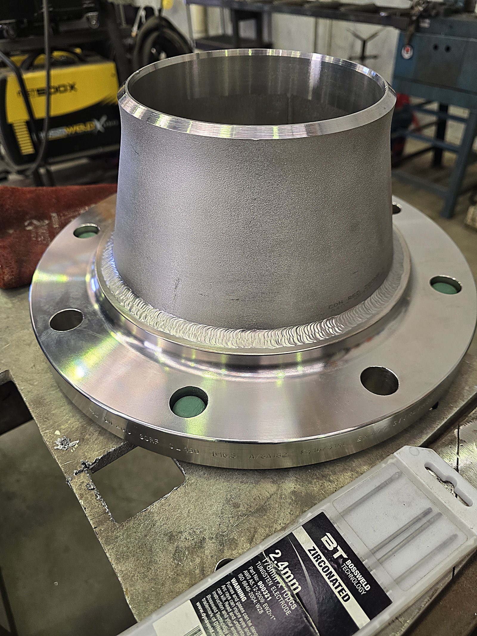 Coded stainless TIG weld joining a concentric reducer to a 150lb flange
